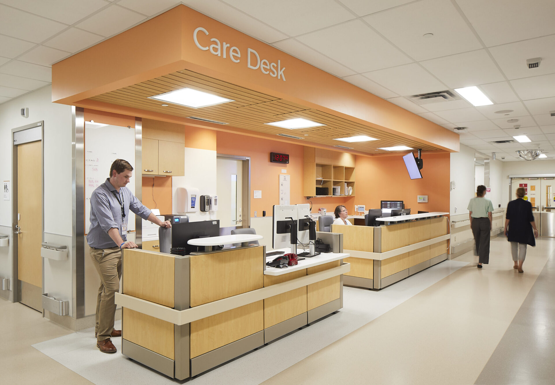A person standing at an architectural desk in a hospital.