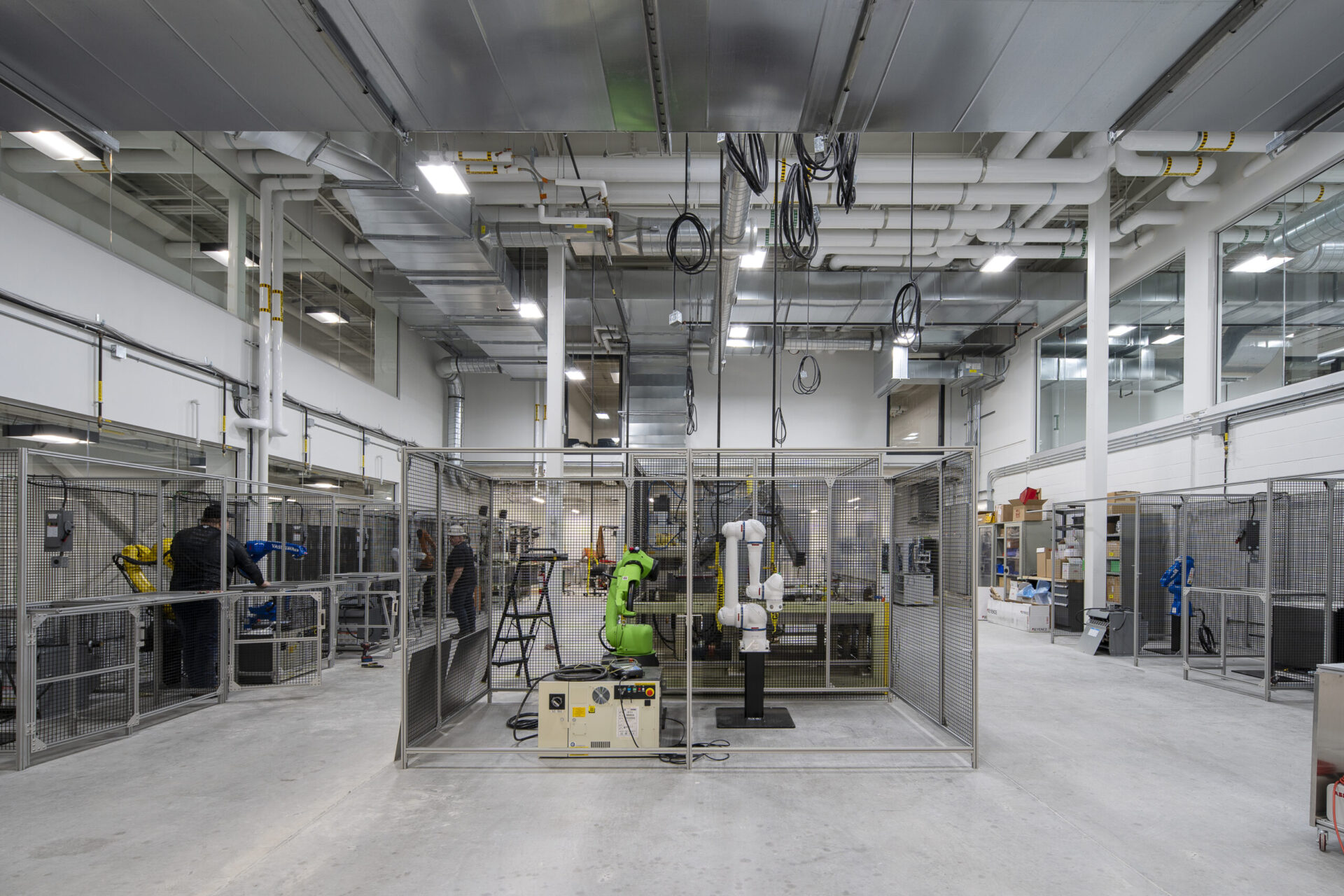 The interior of a factory with architectural metal cages.