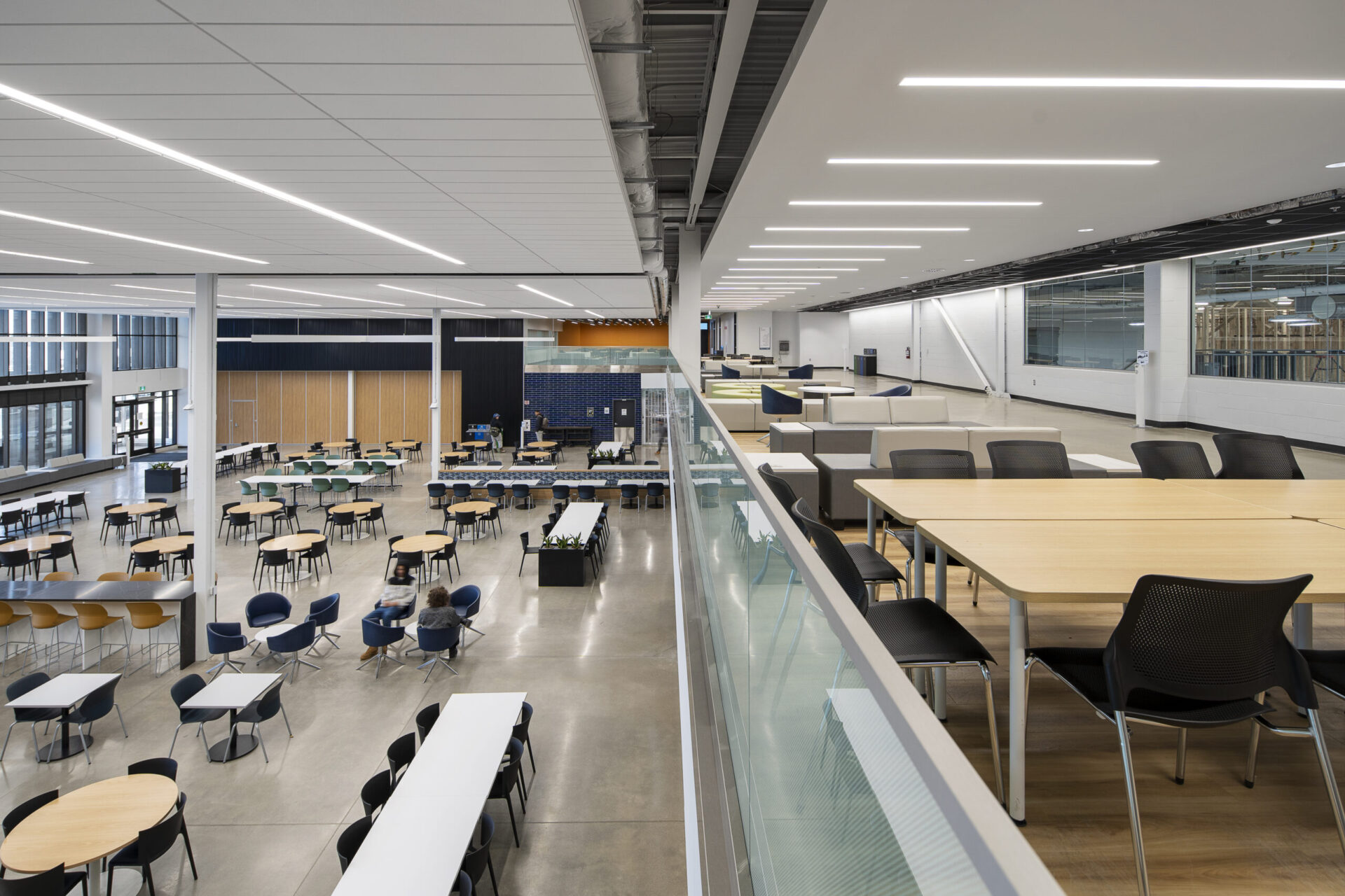 An architecturally designed open space with tables and chairs.