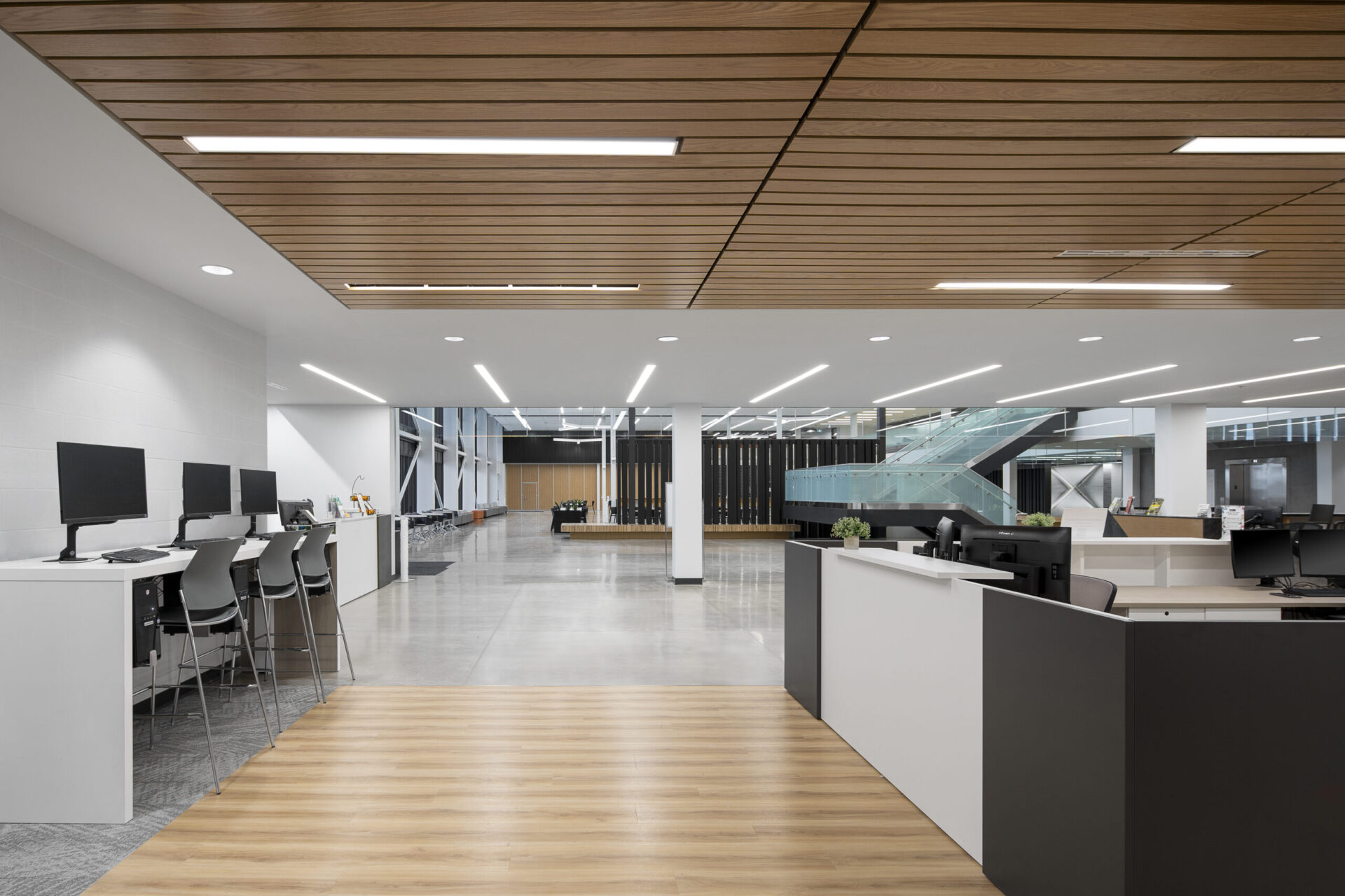 A modern office building with wooden ceilings and desks.