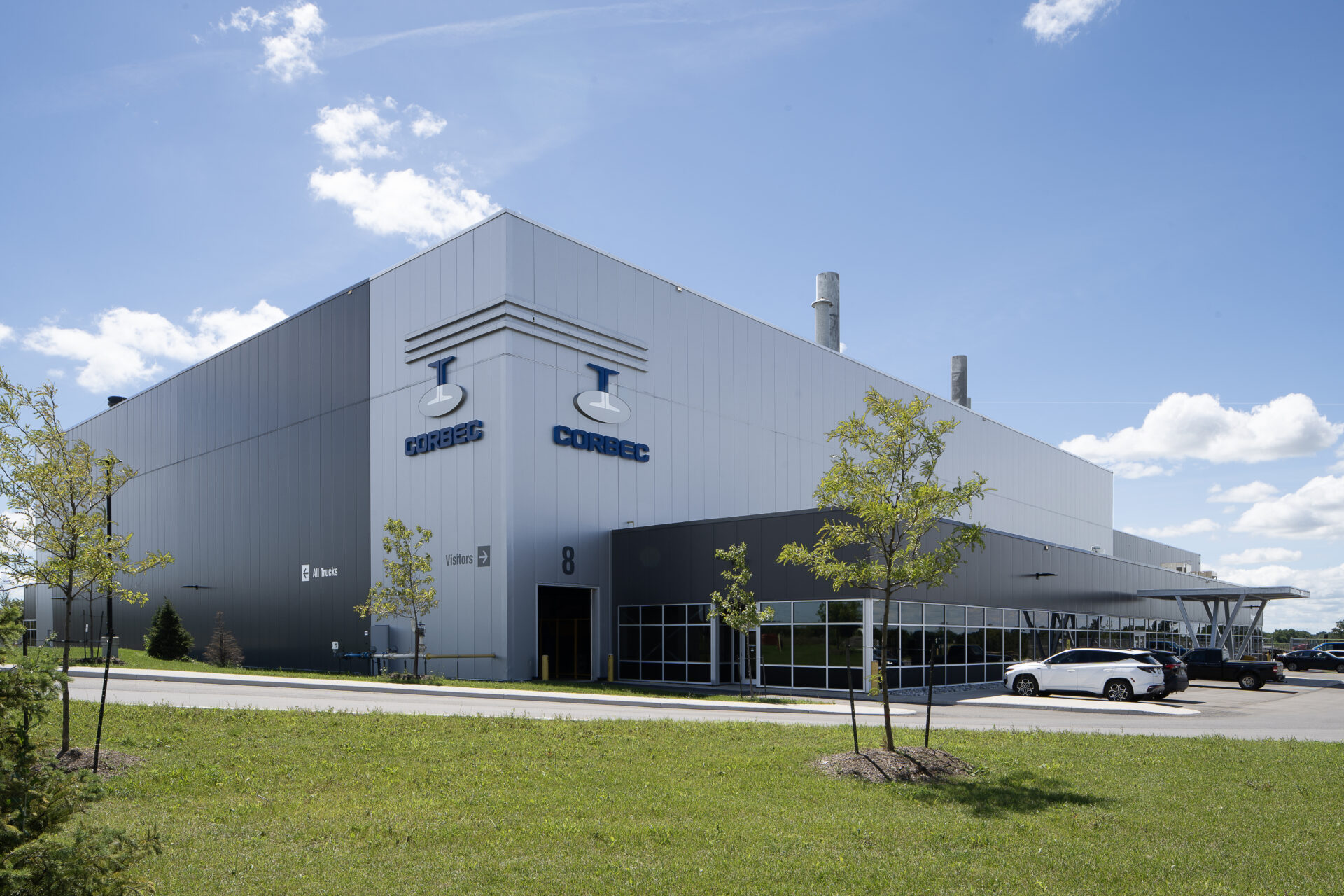 A steel galvanizing plant with a car parked in front of it.