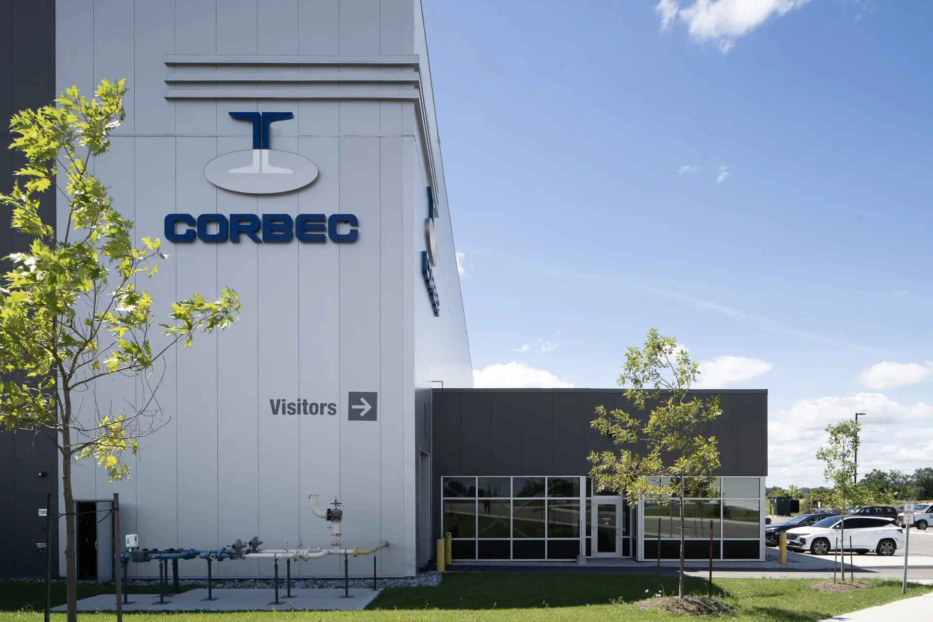 A steel building with a sign that says corbec, possibly a steel galvanizing plant.