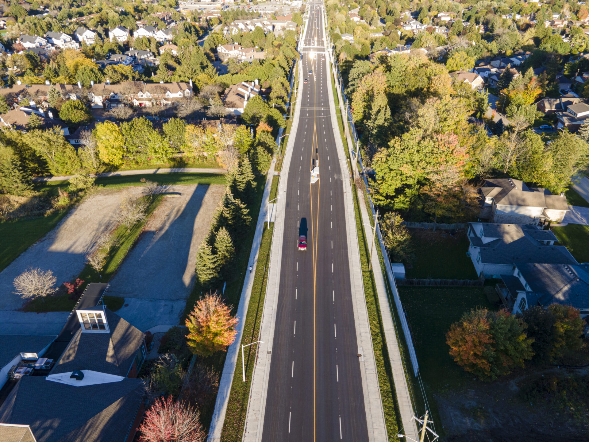 An aerial view of an engineered highway in a residential area.