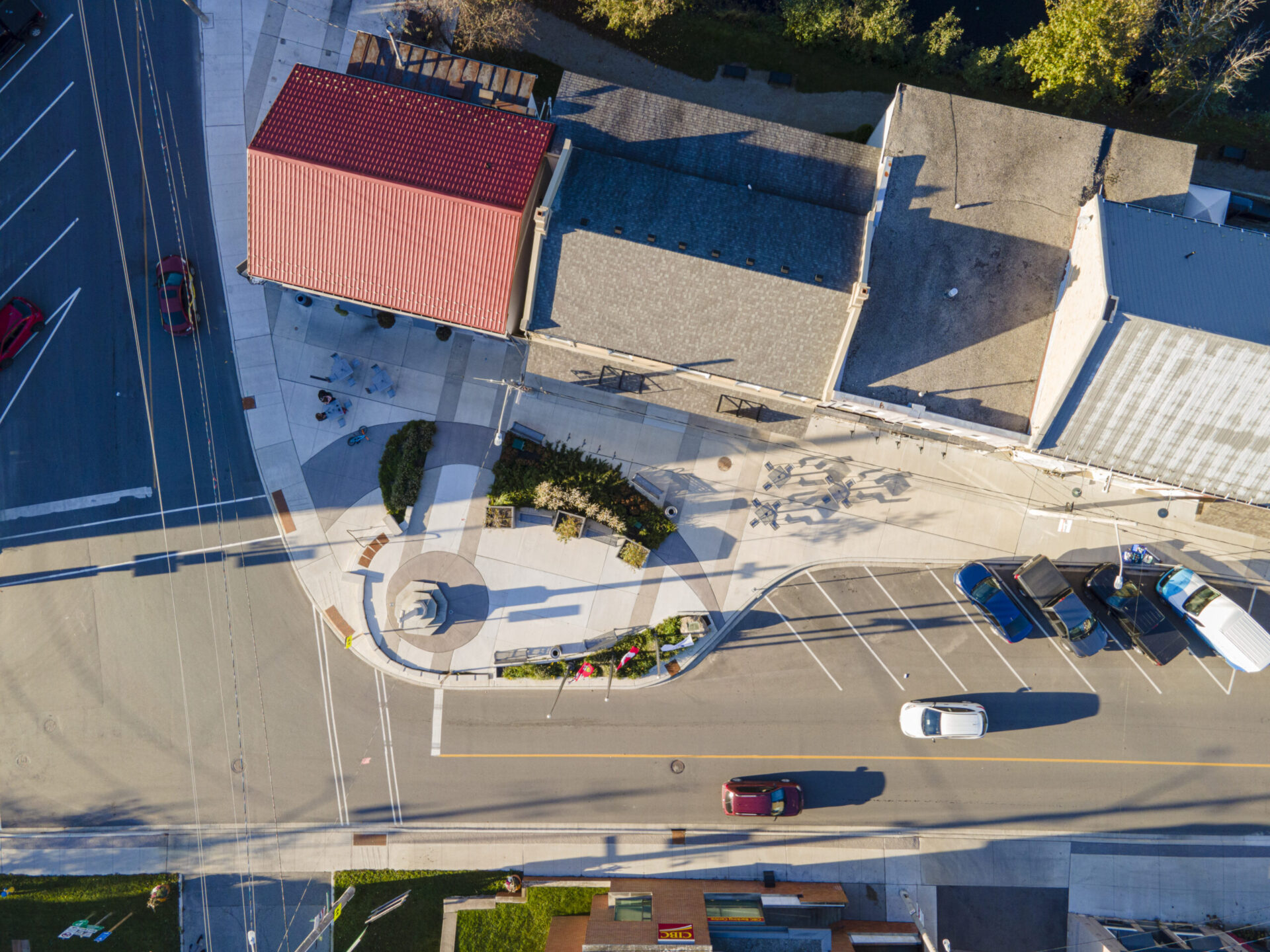 An aerial view of an engineered street with parked cars on it.