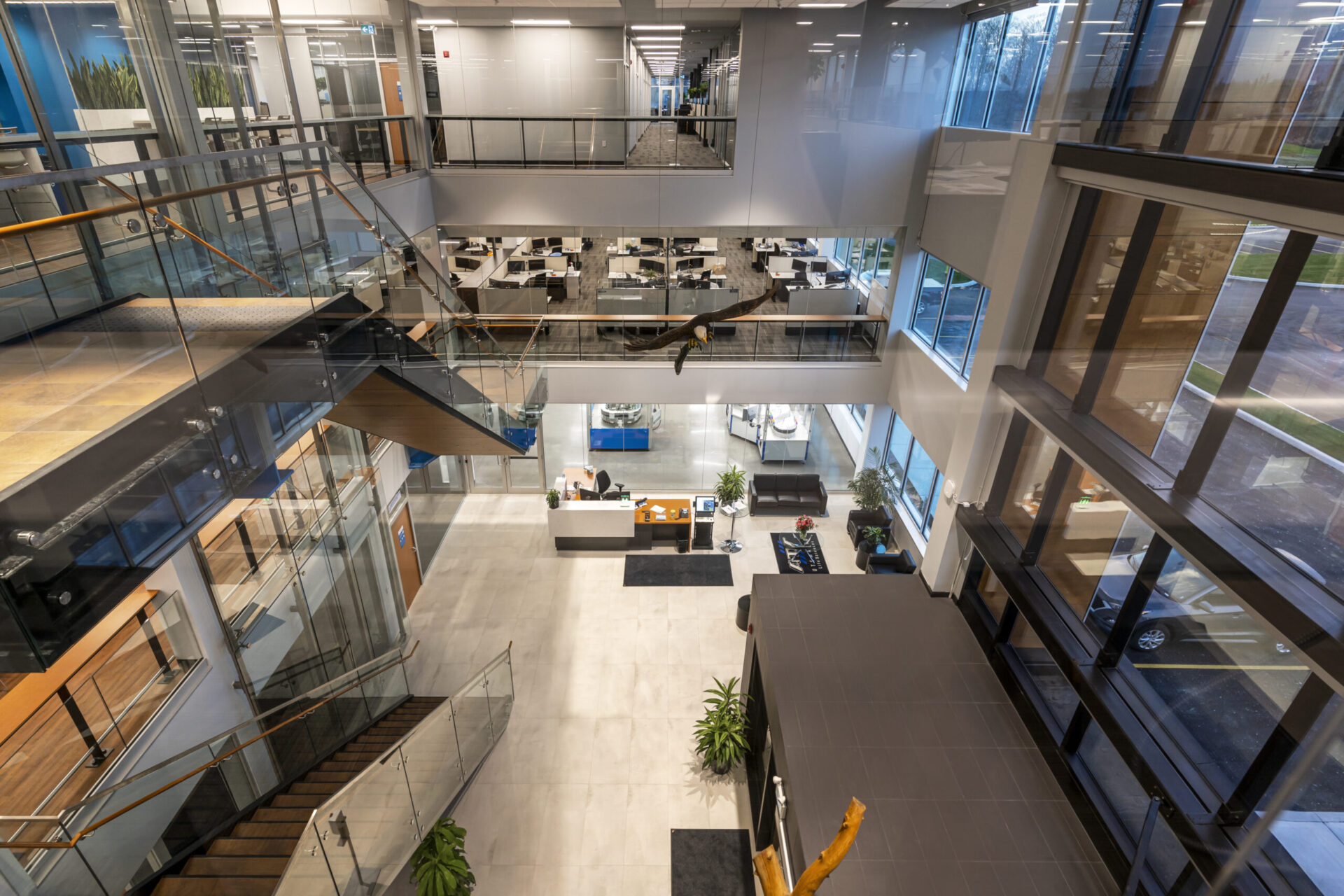 An architecturally stunning office building featuring glass walls and stairs.