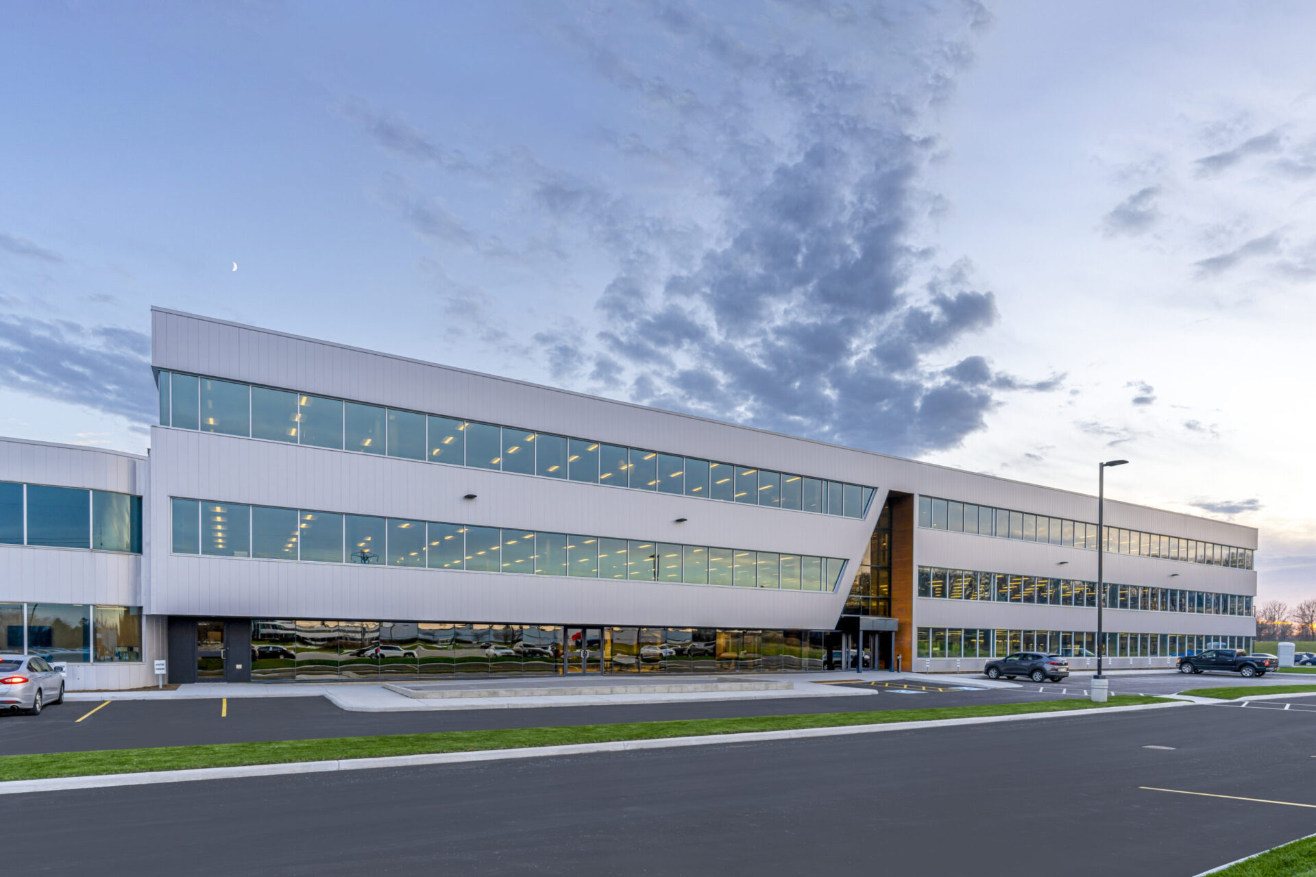 The architectural design of a large office building at dusk showcases superior engineering.