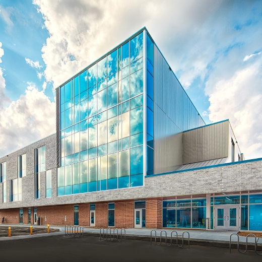 A rendering of the exterior of an architecturally designed school building.