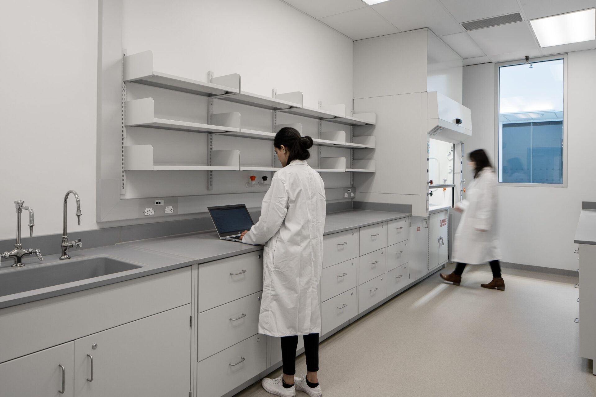 Two women in lab coats working in an architectural lab.