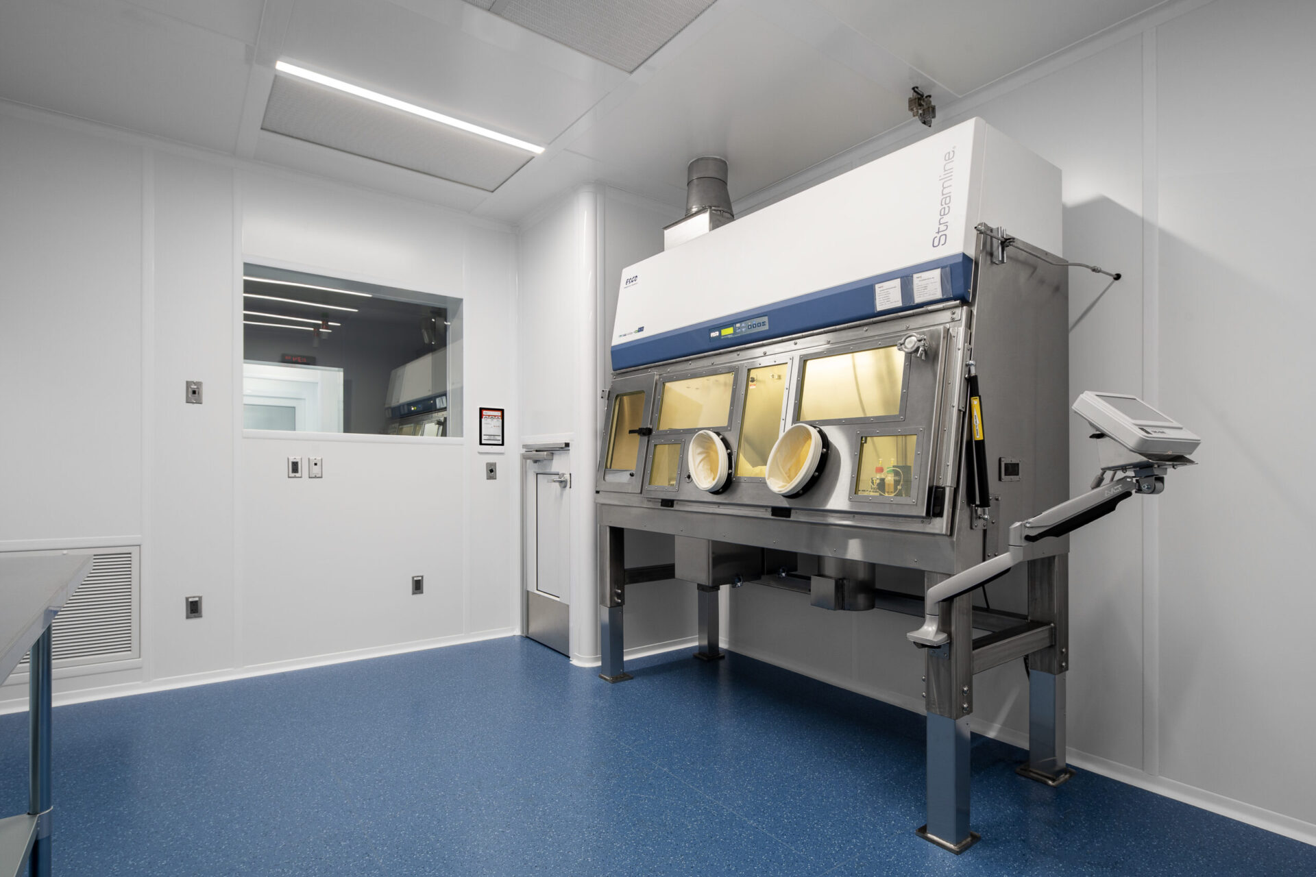 An architecturally designed room featuring a machine and a vibrant blue floor.