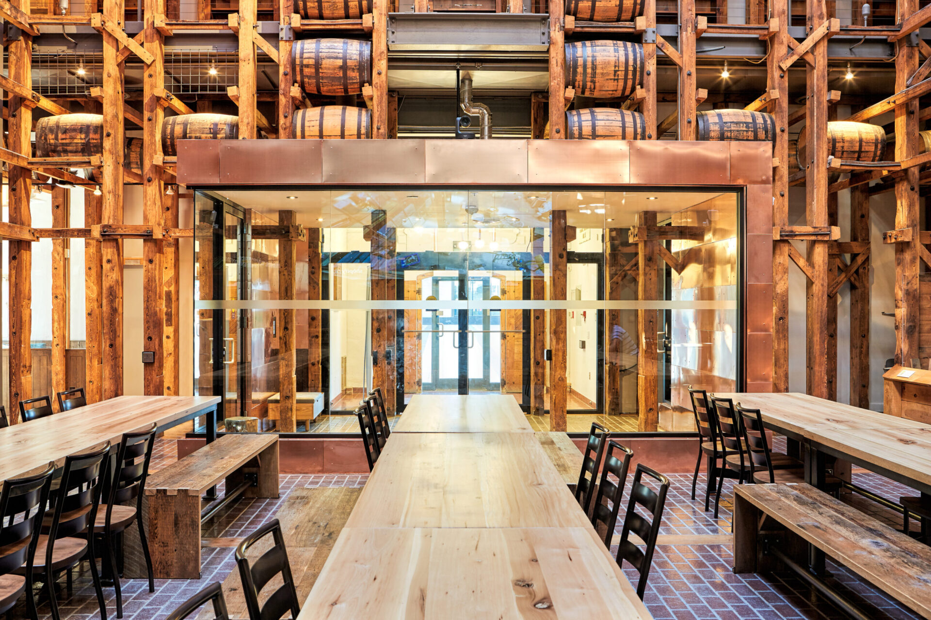 A restaurant with wooden tables and chairs featuring architectural design.