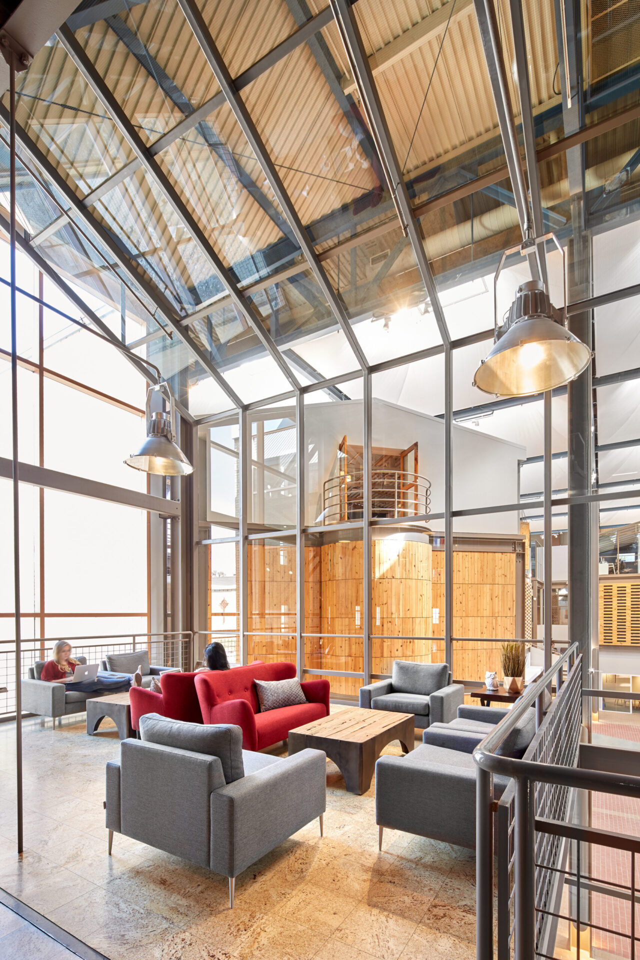 A large open space with a large glass wall showcasing innovative architecture and engineering.