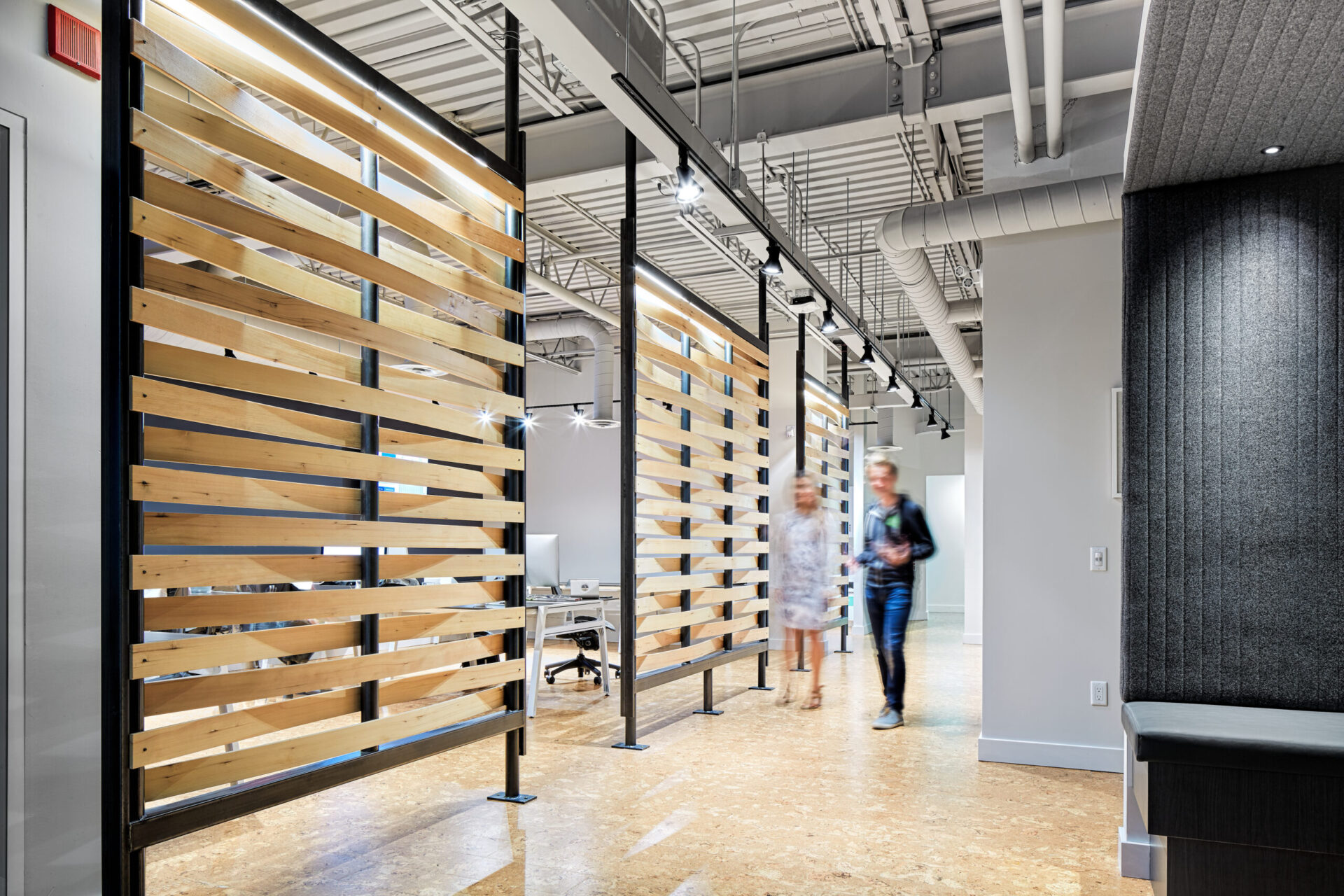 An architecturally designed office with wooden slats in the hallway.