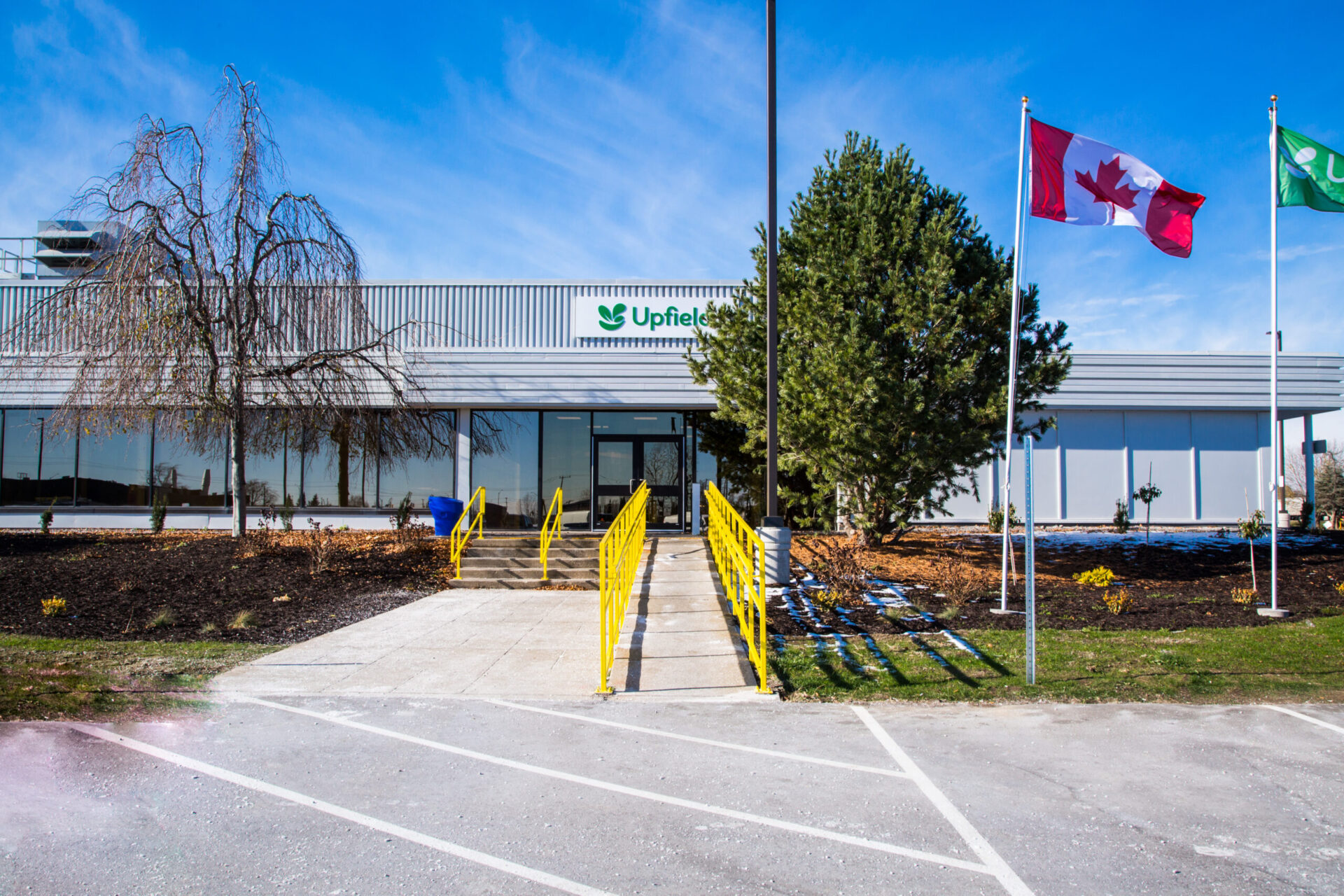 A building featuring both engineering and architecture, with a Canadian flag flying in front.