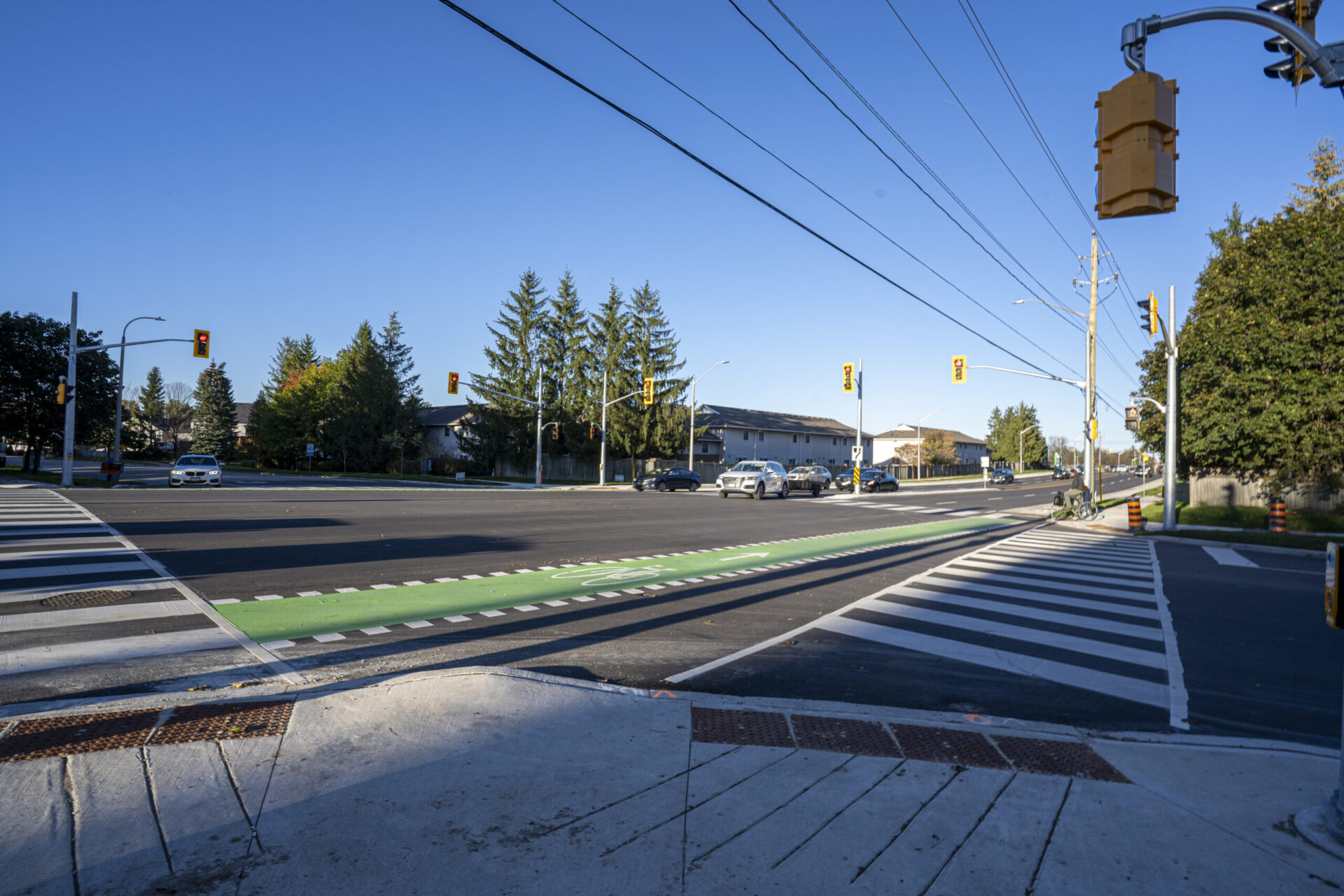 An engineered street intersection with a traffic light and an architectural street sign.