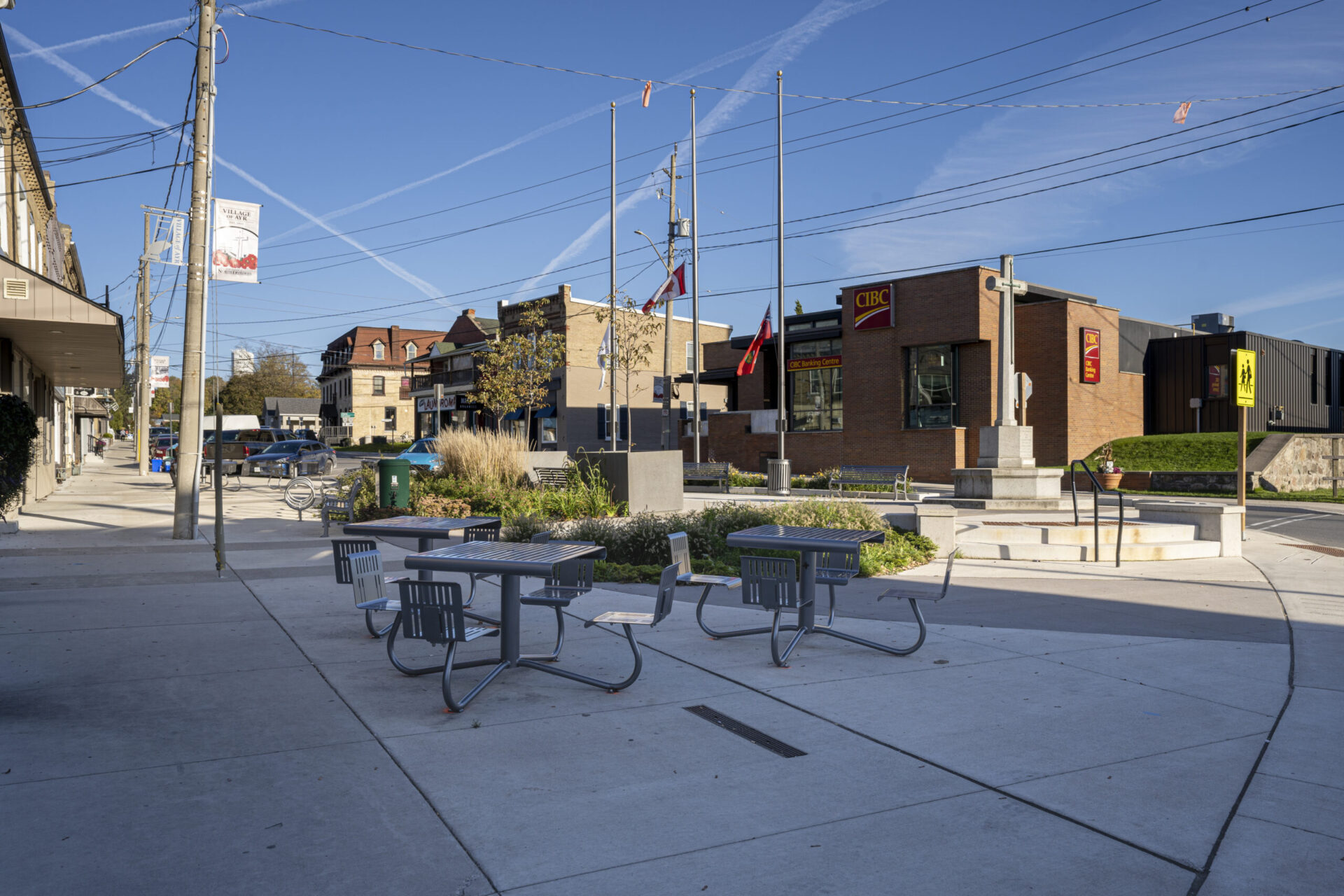 A sidewalk designed with tables and chairs combining engineering with architecture.