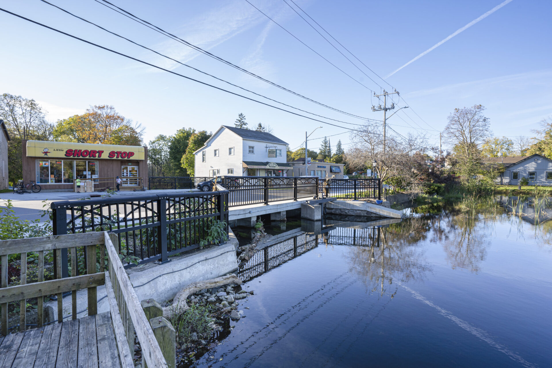 An engineering marvel, a picturesque bridge over a serene waterway near a charming town.