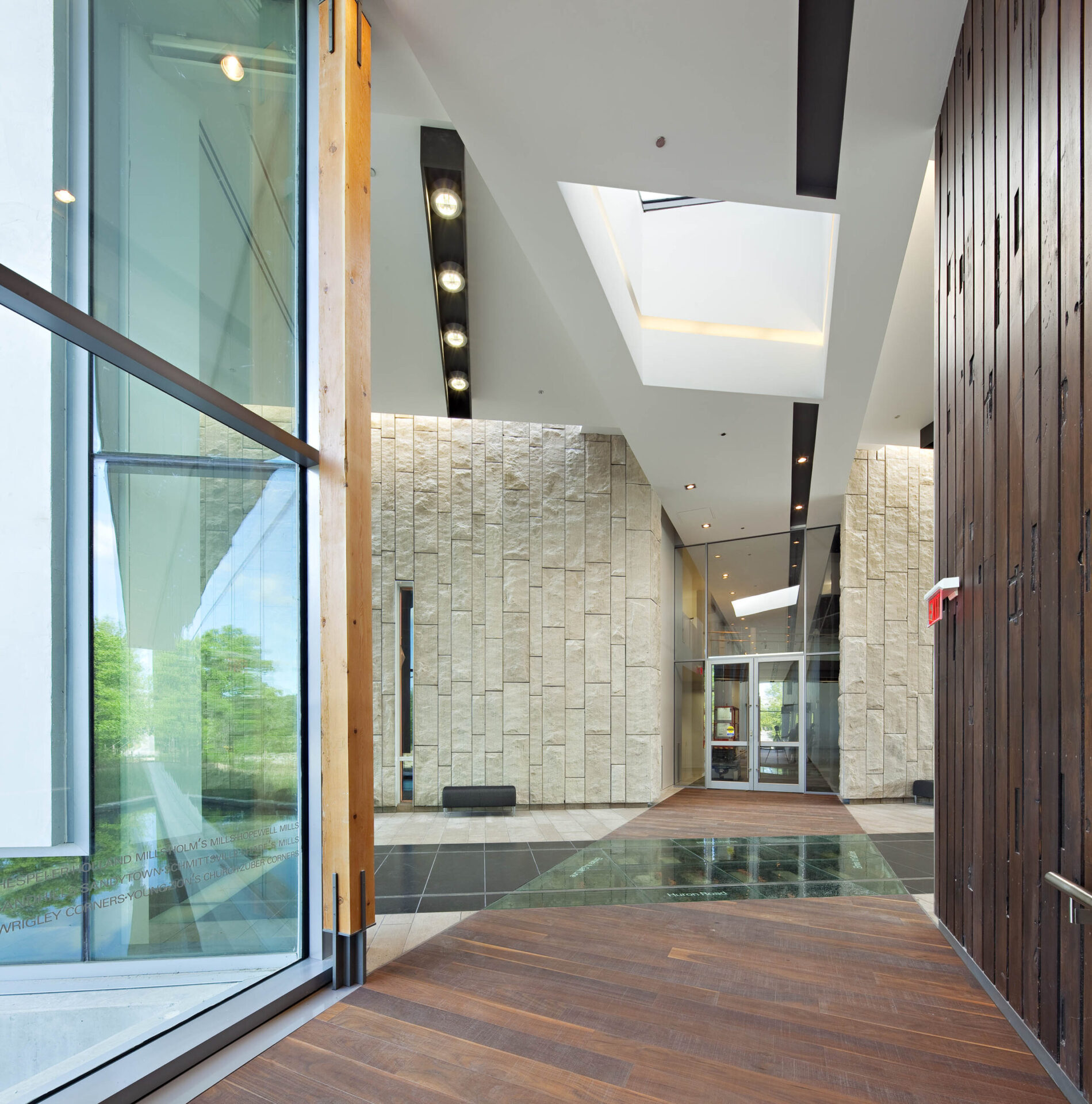 A wooden floor in a hallway with architectural charm.
