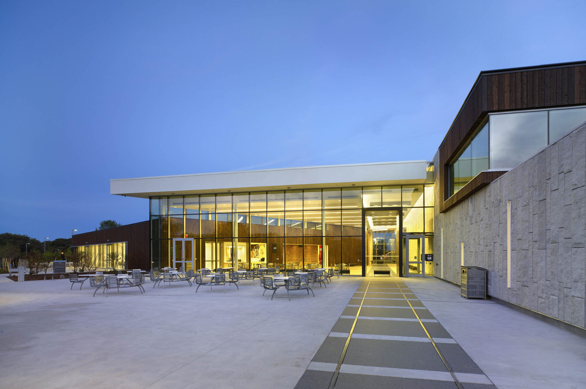 A building with a large glass facade showcasing architectural brilliance at dusk.