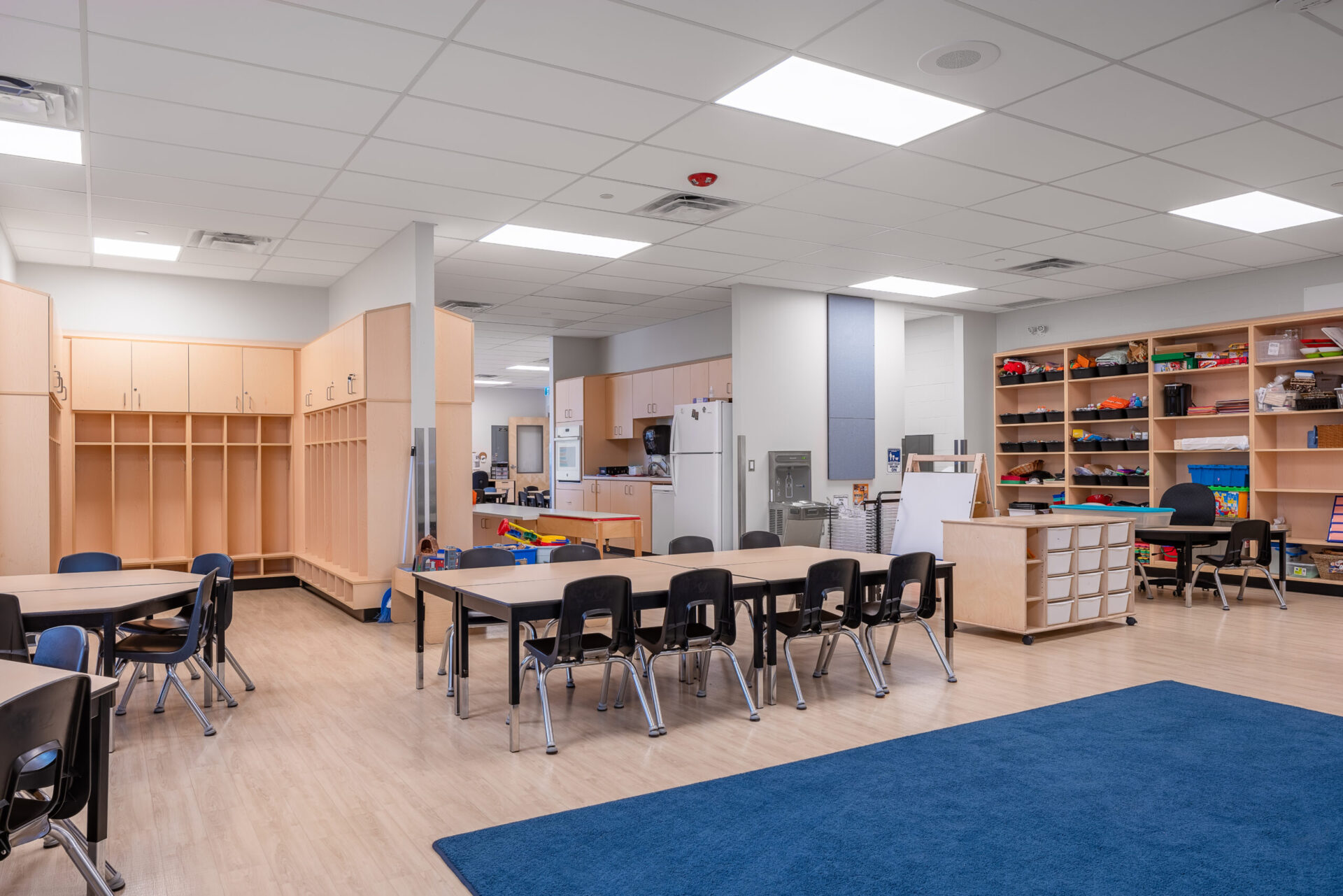 A classroom with tables and chairs designed for optimal architecture.