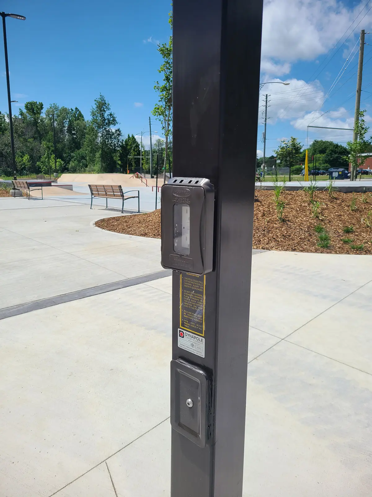 An electrical plug in a pole in a park, located at the Albert McCormick Community Centre.
